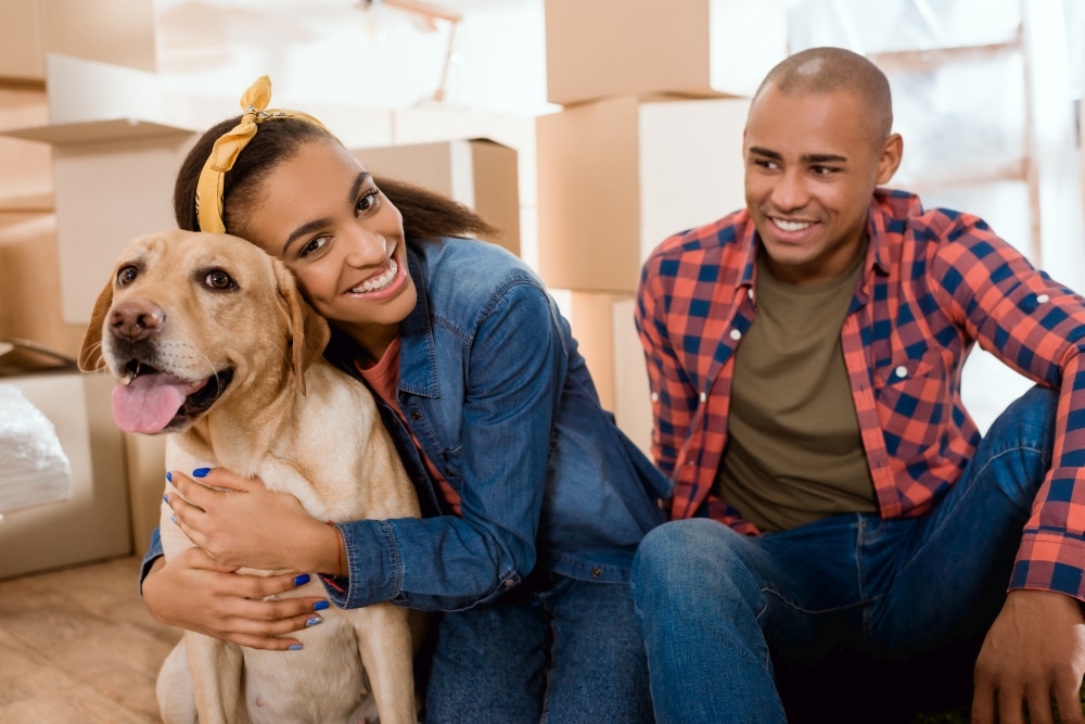 happy african american family with labrador dog moving to new ap